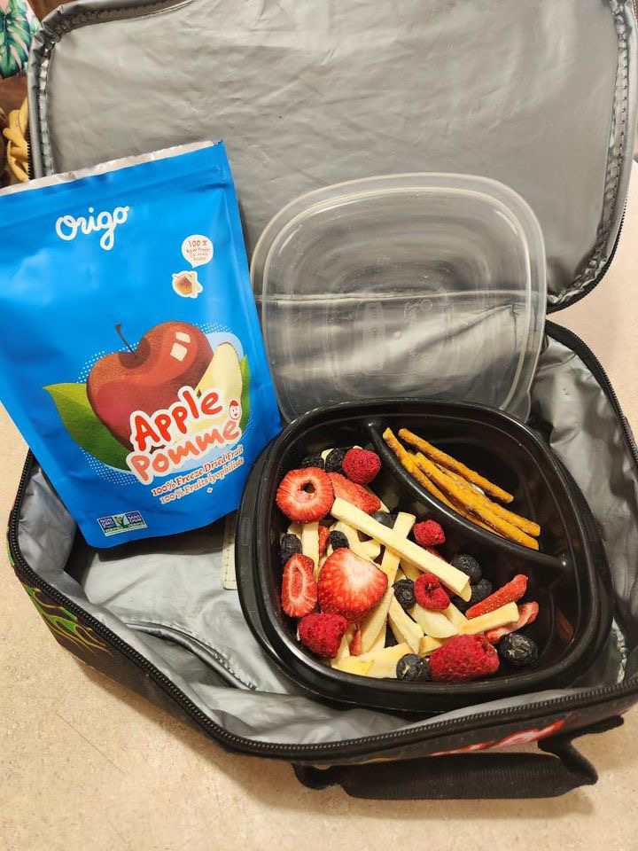 Open lunch bag with an Origo Apple freeze-dried fruit pouch and mixed freeze-dried fruit