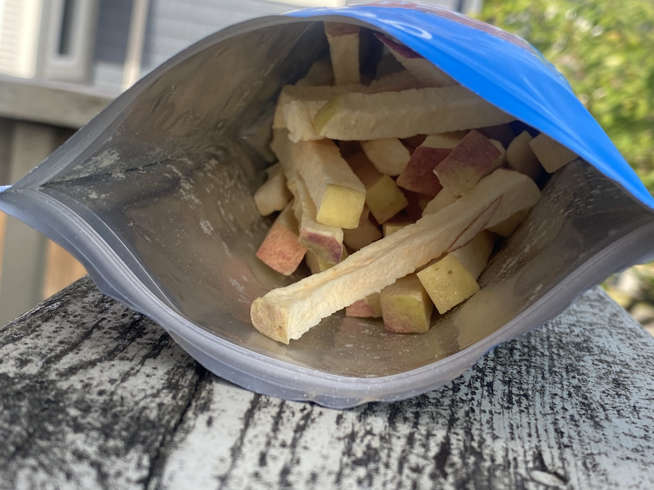 An open pouch of Origo freeze-dried apple pieces ready to eat